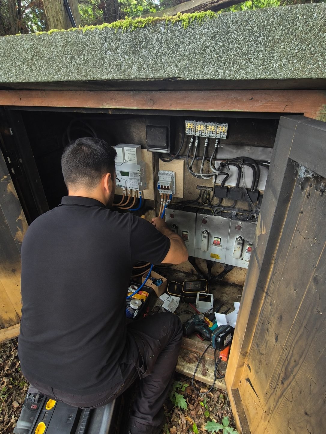 Electrician testing a repaired circuit before restoring power